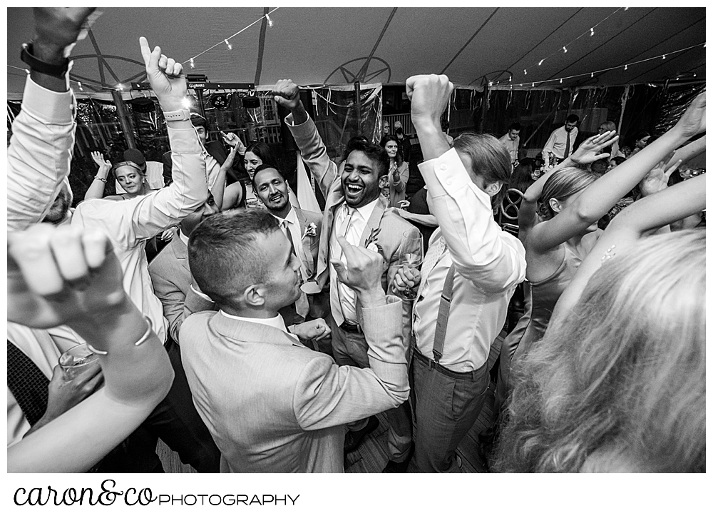 black and white photo of wedding guests dancing at a tented breakwater inn Kennebunkport wedding reception