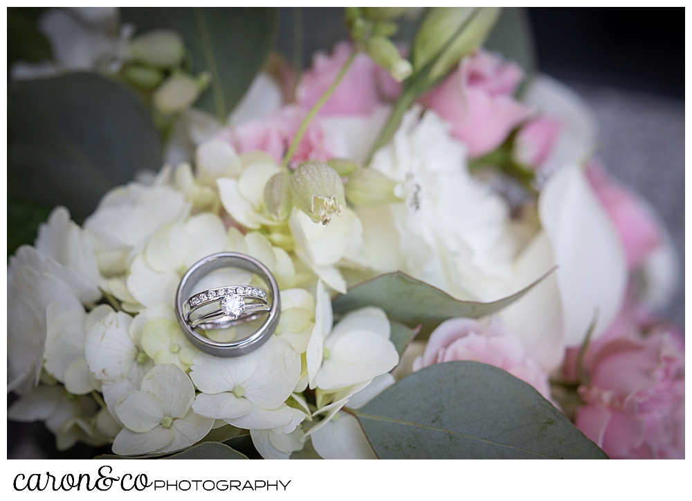 bridal details with a pink, white, and green bridal bouquet, and wedding rings