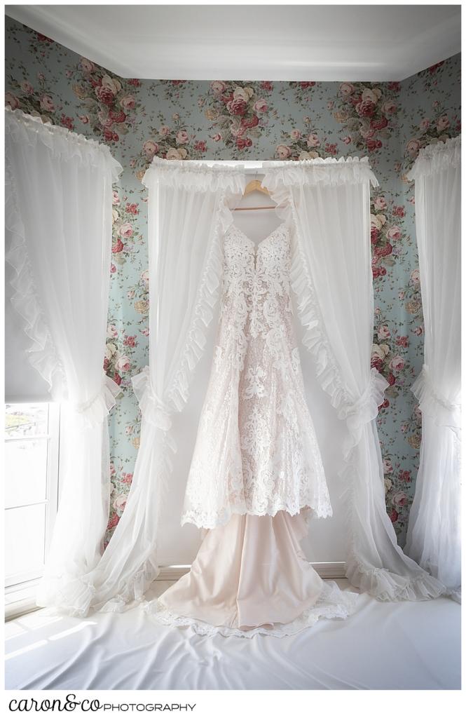 a wedding dress hanging in a window at the colony hotel Kennebunkport Maine