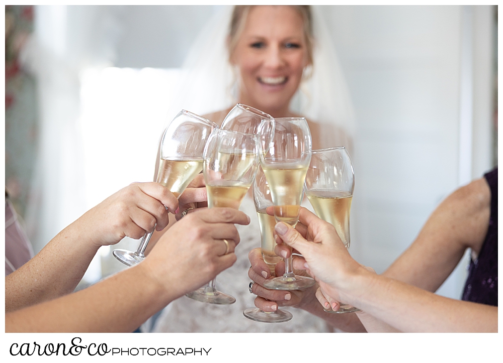champagne flutes toasting in the foreground, while a smiling bride is in the background