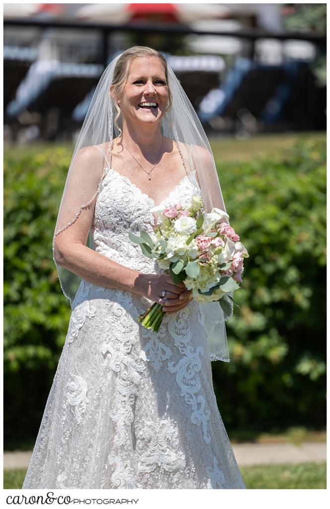 a bride smiles during her wedding day first look at a Kennebunkport Maine colony hotel wedding
