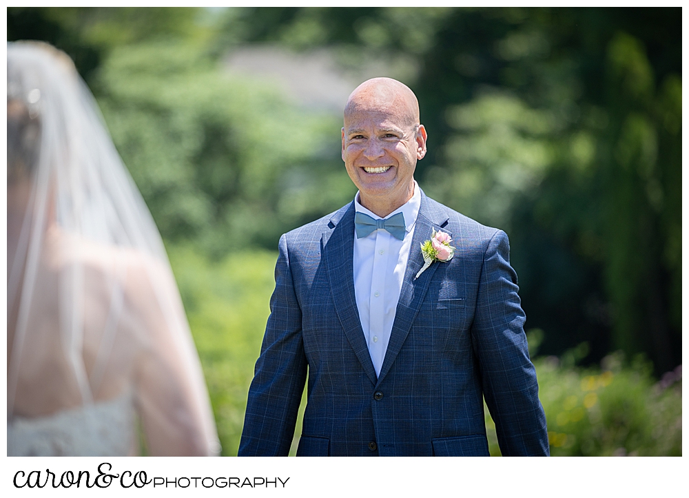 a groom is all smiles as he see his groom for the first time at their wedding day first look at the colony hotel Kennebunkport maine