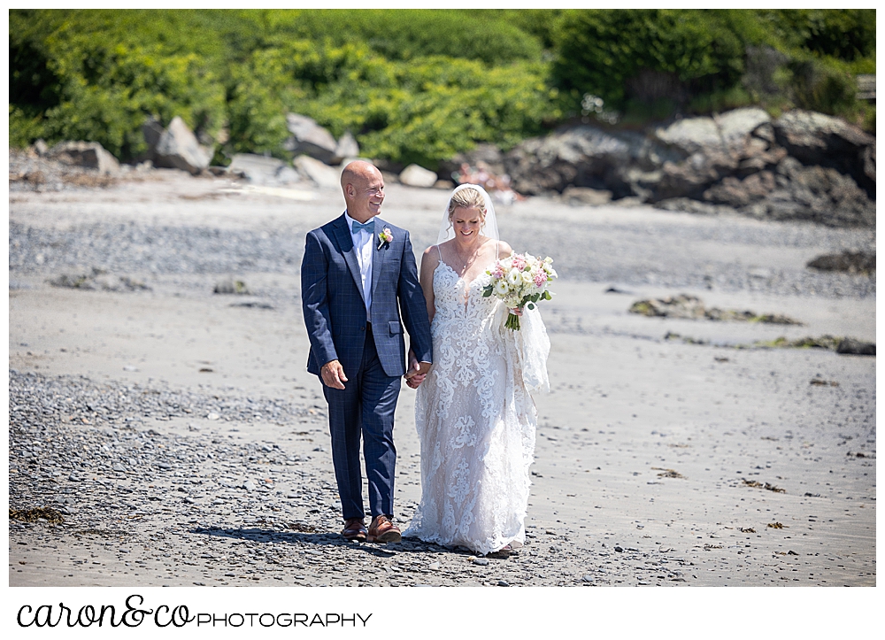 a bride and groom walk side by side on colony beach in Kennebunkport Maine