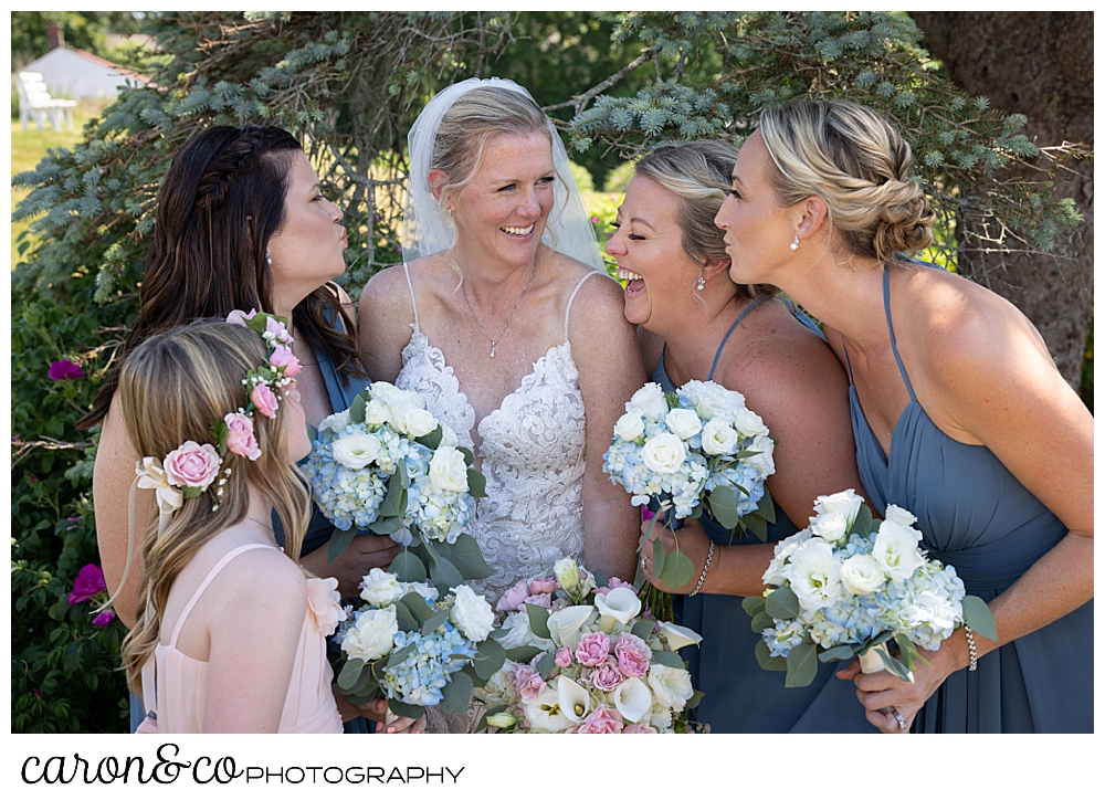 a bride is surrounded by bridesmaids laughing