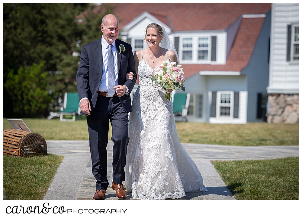 a bride and her father walk down the aisle at an outdoor Kennebunkport Maine colony hotel wedding