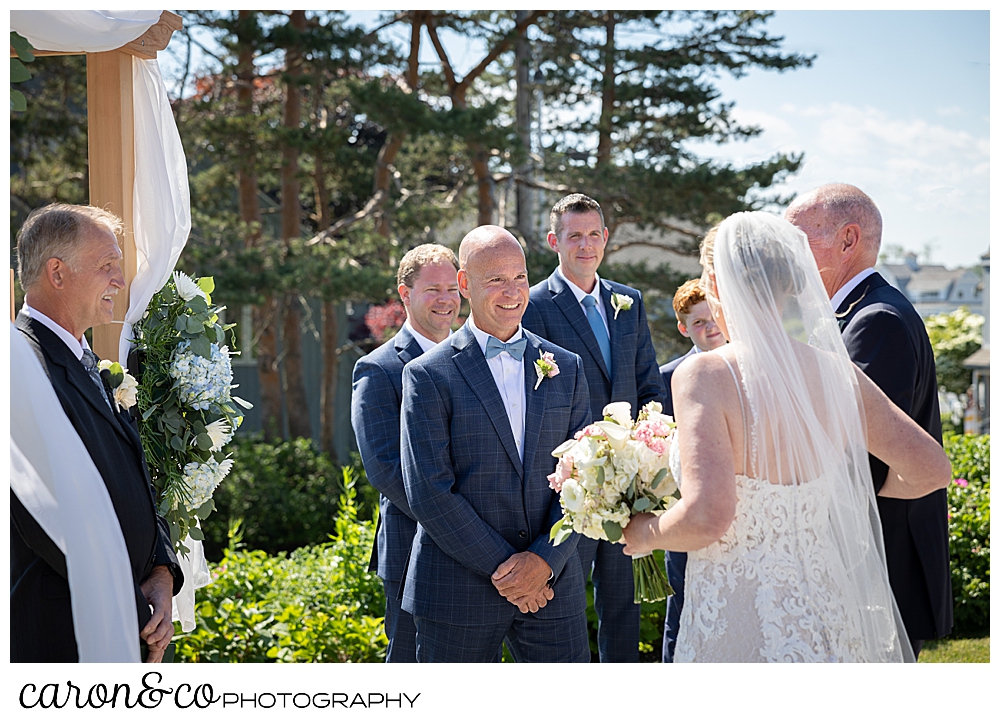 a bride and her father reach the outdoor ceremony site at a Kennebunkport Maine colony hotel wedding