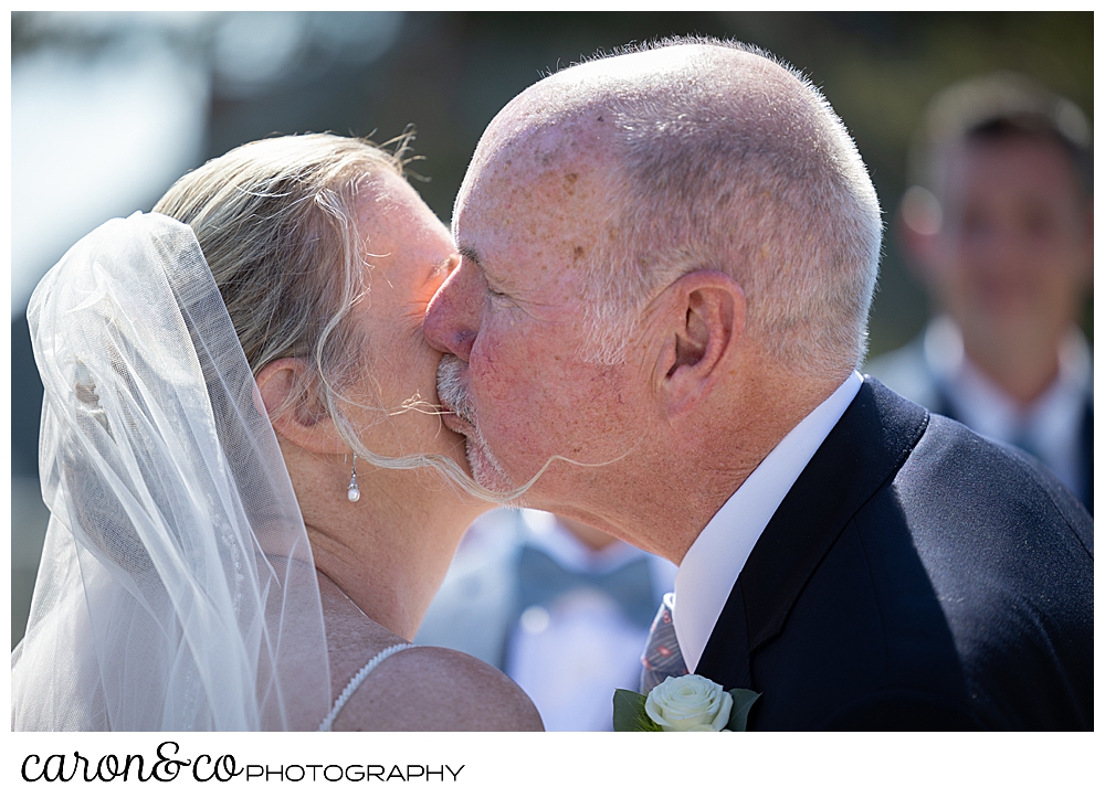 a father kisses his daughter, the bride, at a Kennebunkport Maine colony hotel wedding