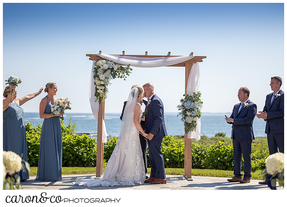 a bride and groom's first kiss at a Kennebunkport Maine colony hotel wedding ceremony