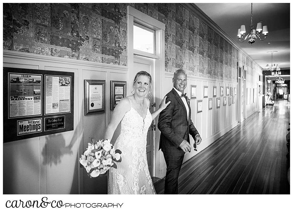 black and white photo of a bride and groom escaping to their cocktail hour at a Kennebunkport Maine colony hotel wedding reception