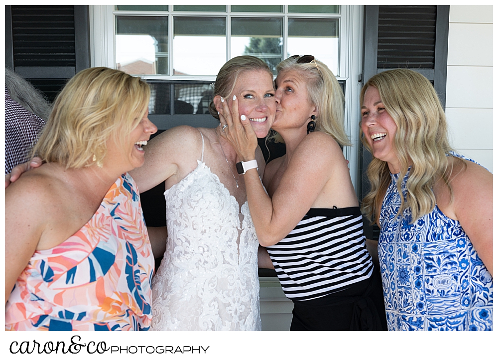 a wedding guest kisses the bride during a Kennebunkport Maine colony hotel wedding reception