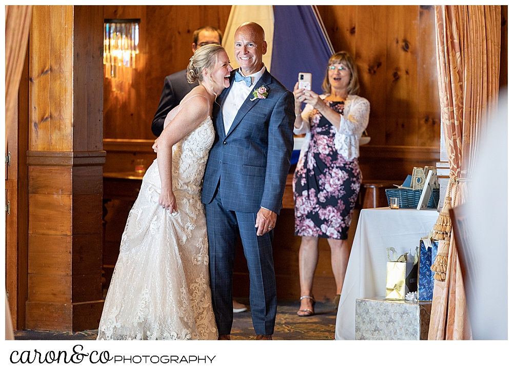 a bride is laughing as she and her groom wait to be announced into their Kennebunkport Maine colony hotel wedding reception
