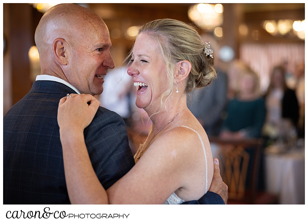 a bride laughs during her first dance with her groom at a Kennebunkport Maine colony hotel wedding reception