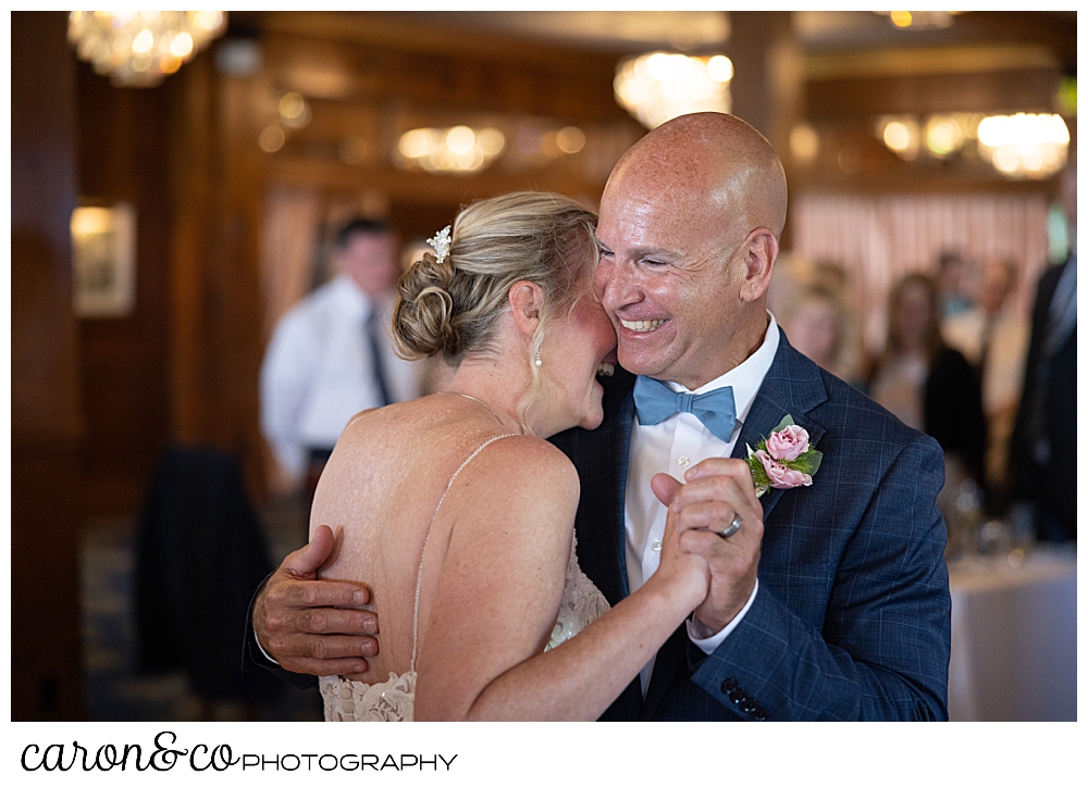 a bride and groom are laughing during their first dance at a Kennebunkport Maine colony hotel wedding reception