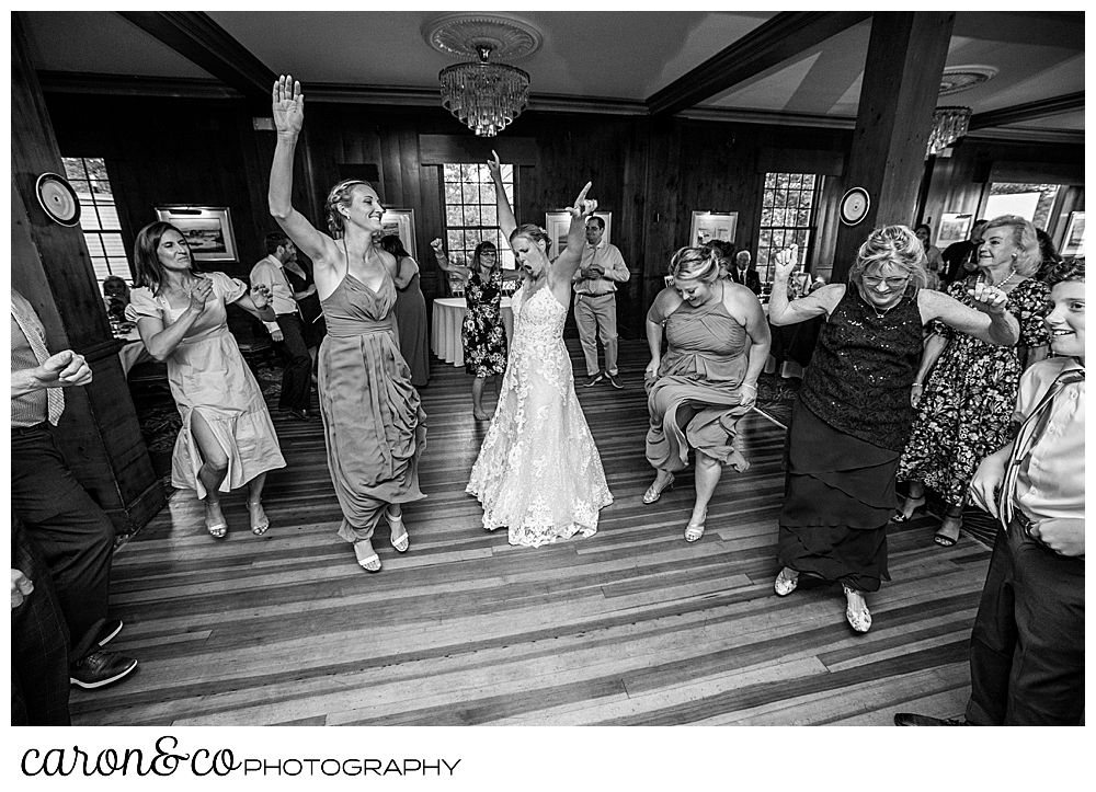 black and white photo of a bride dancing with bridesmaids and guest at a colony hotel Kennebunkport Maine wedding reception