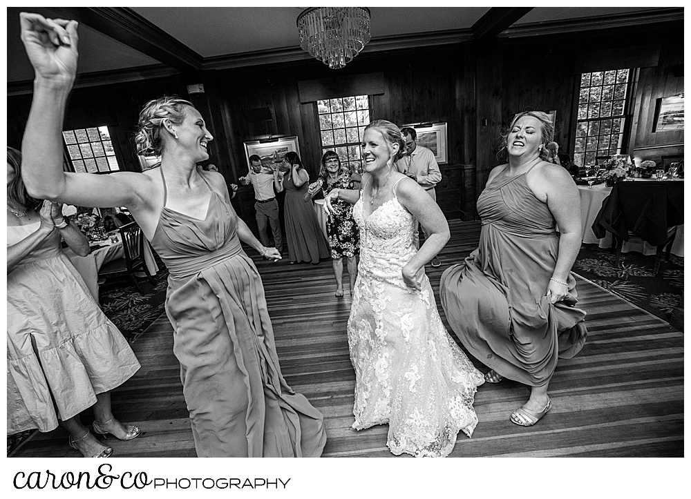 black and white photo of a bride dancing with her bridesmaids at a Kennebunkport Maine colony hotel wedding reception