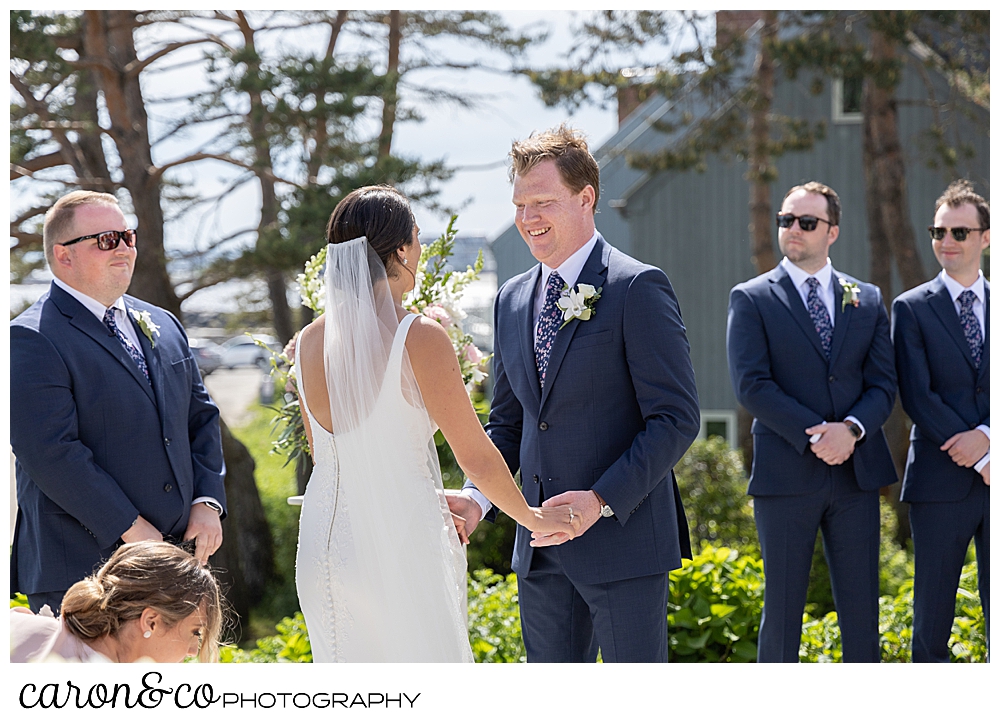a groom smiles at his bride during their Kennebunkport Maine wedding at the colony hotel