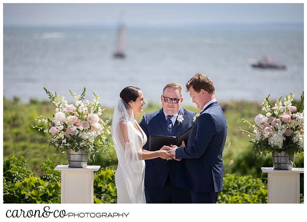 a bride and groom stand before a wedding officiant at their Kennebunkport Maine wedding at the Colony Hotel
