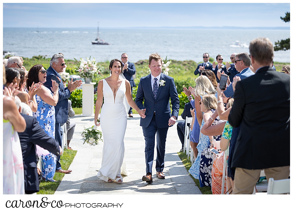 The bride and groom begin their recessional at their Kennebunkport Maine wedding at the colony hotel