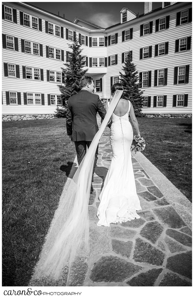 a black and white photo of a bride and groom as they recess during their Kennebunkport Maine wedding at the colony hotel