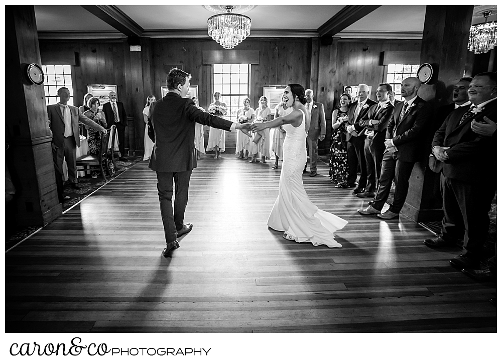 a black and white photo of a bride and groom during their first dance at a Kennebunkport Maine wedding at the colony hotel