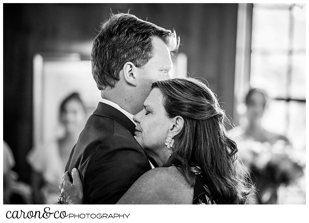 a mother hugs her son during the mother son dance