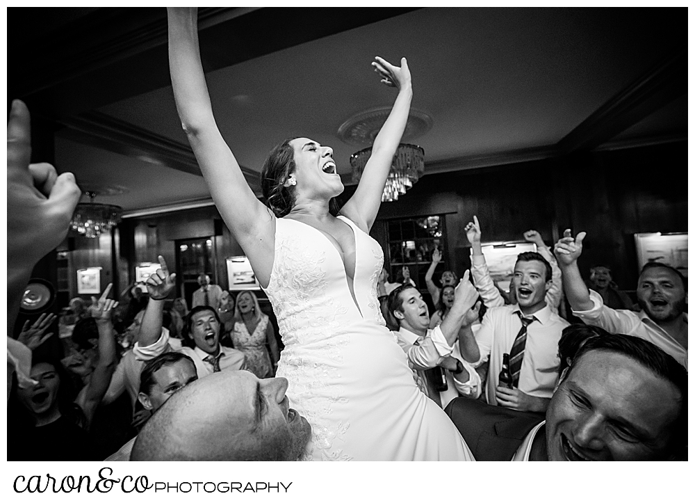 a bride is lifted into the air on the dance floor at her colony hotel Kennebunkport Maine wedding reception