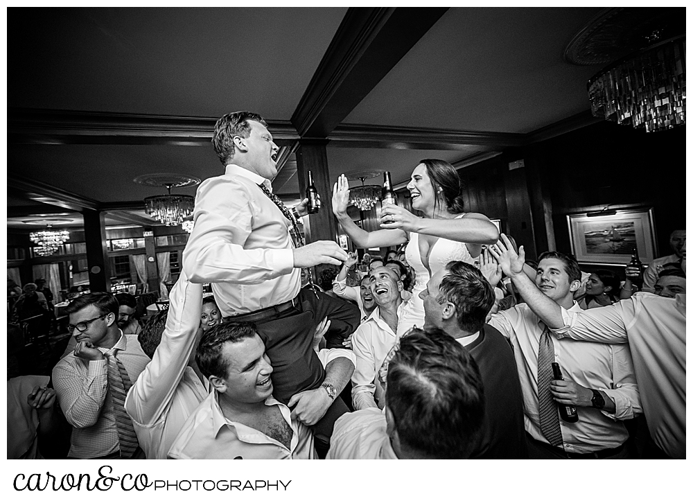 a groom is lifted into the air during the dance party at his colony Hotel wedding in Kennebunkport Maine