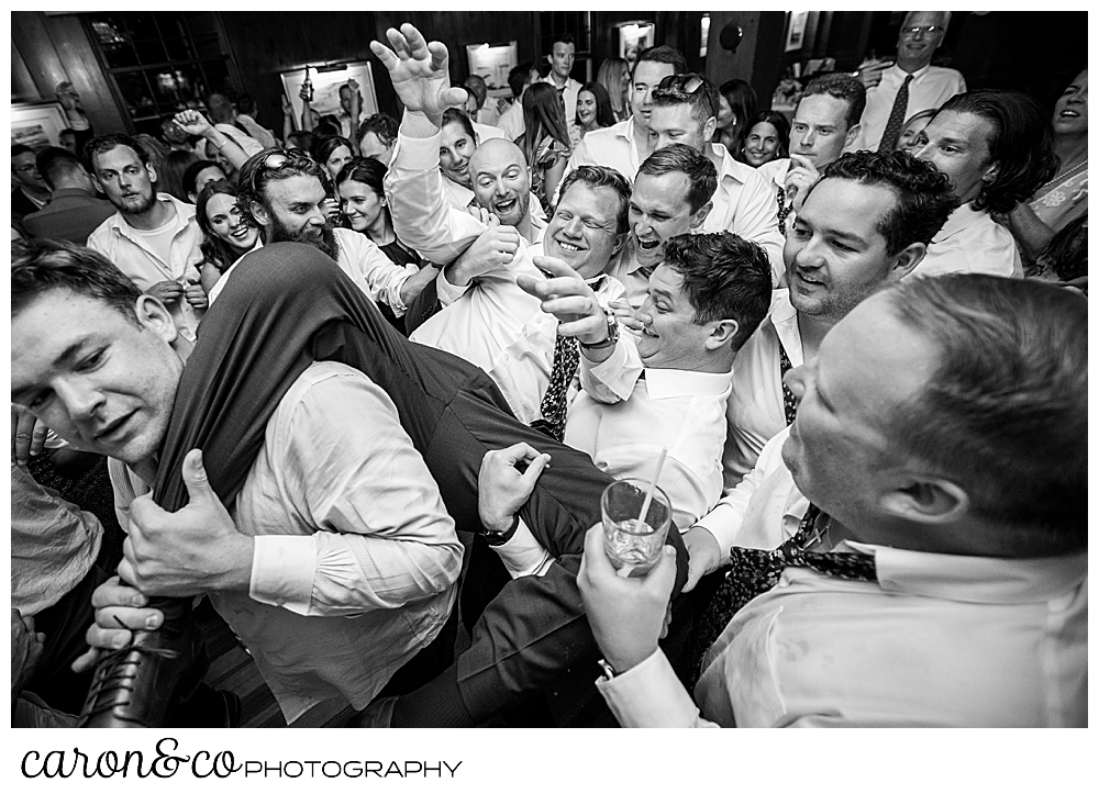 a groom crowd surfs on the dance floor at a colony hotel Kennebunkport Maine wedding reception