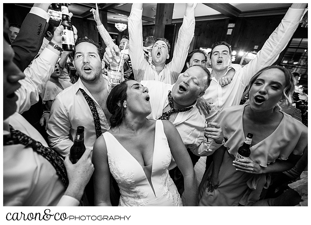 a bride sings on the dance floor during her Kennebunkport Maine wedding at the colony hotel