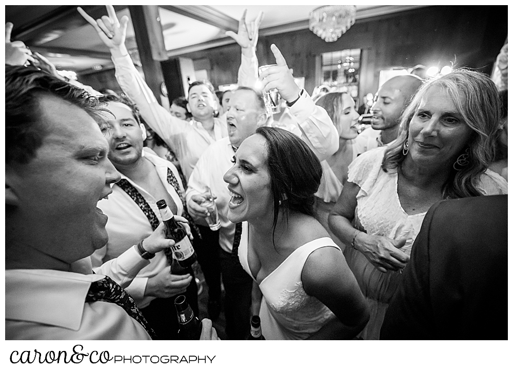 a bride is having a great time on the dance floor with her groom and their friends and family at the colony hotel Kennebunkport Maine wedding
