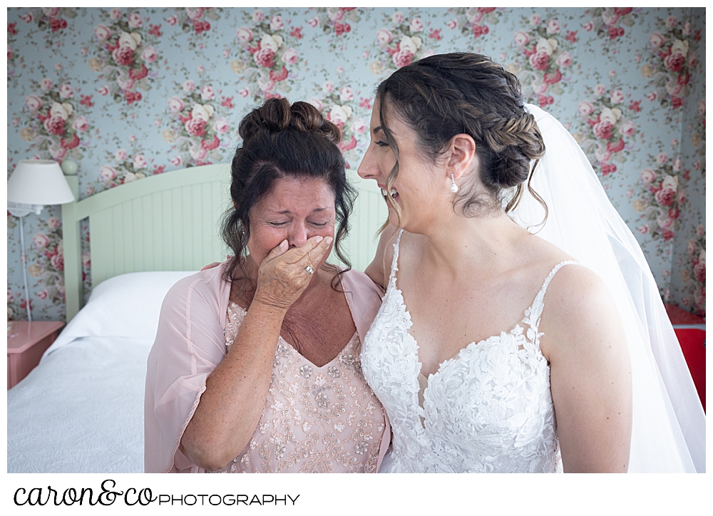 a bride's mother cries, as she see her beautiful daughter dressed in a gorgeous wedding dress