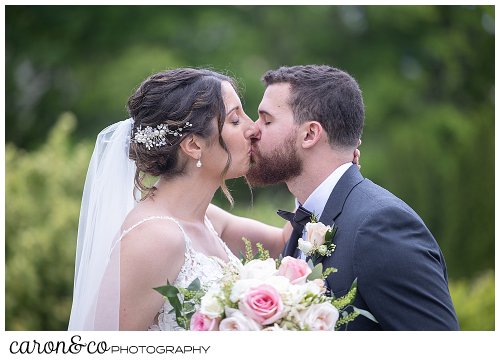 a bride and groom kiss during their wedding day first look at a spring wedding at the colony hotel Kennebunkport Maine