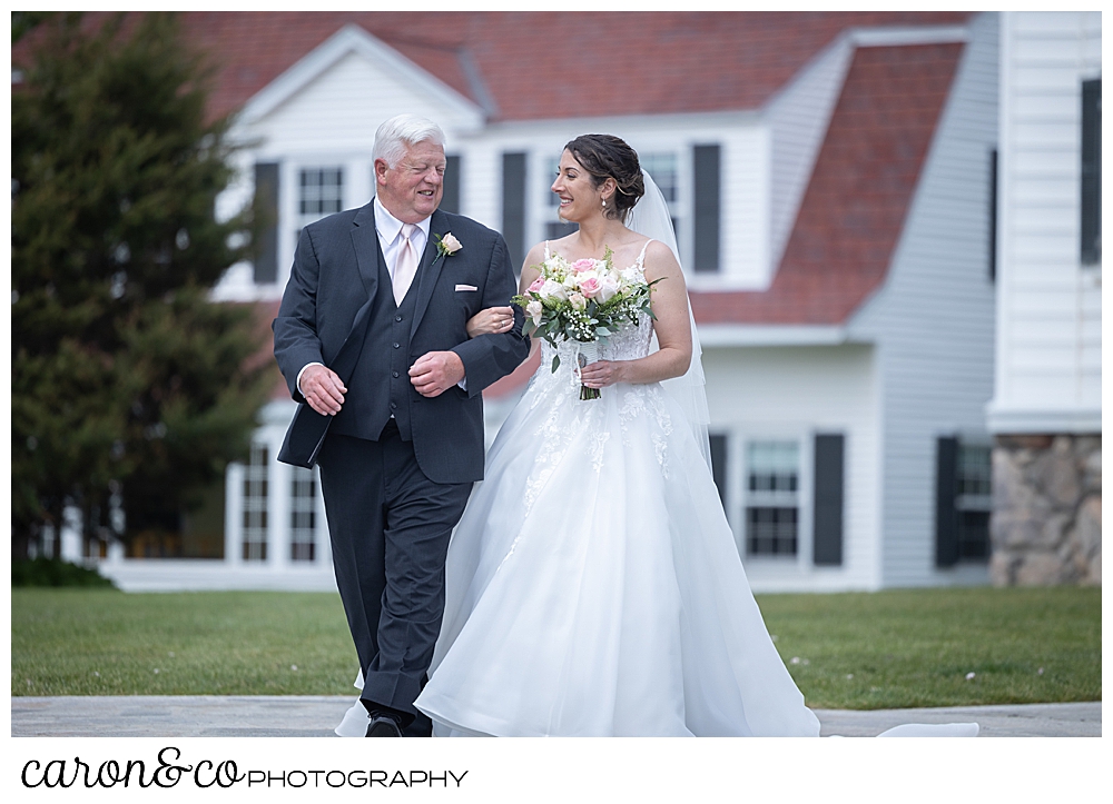 a bride and her dad look at each other as they walk down the aisle at a spring wedding a the colony hotel Kennebunkport Maine