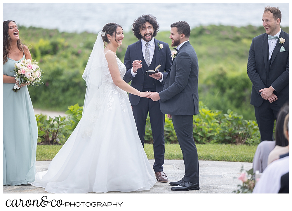 a bride and groom standing before their officiant during a spring wedding at the colony hotel Kennebunkport Maine
