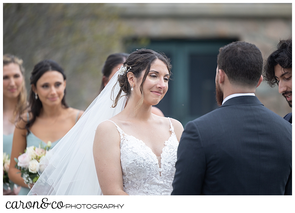a bride smiles at her groom during a spring wedding at the colony hotel Kennebunkport maine