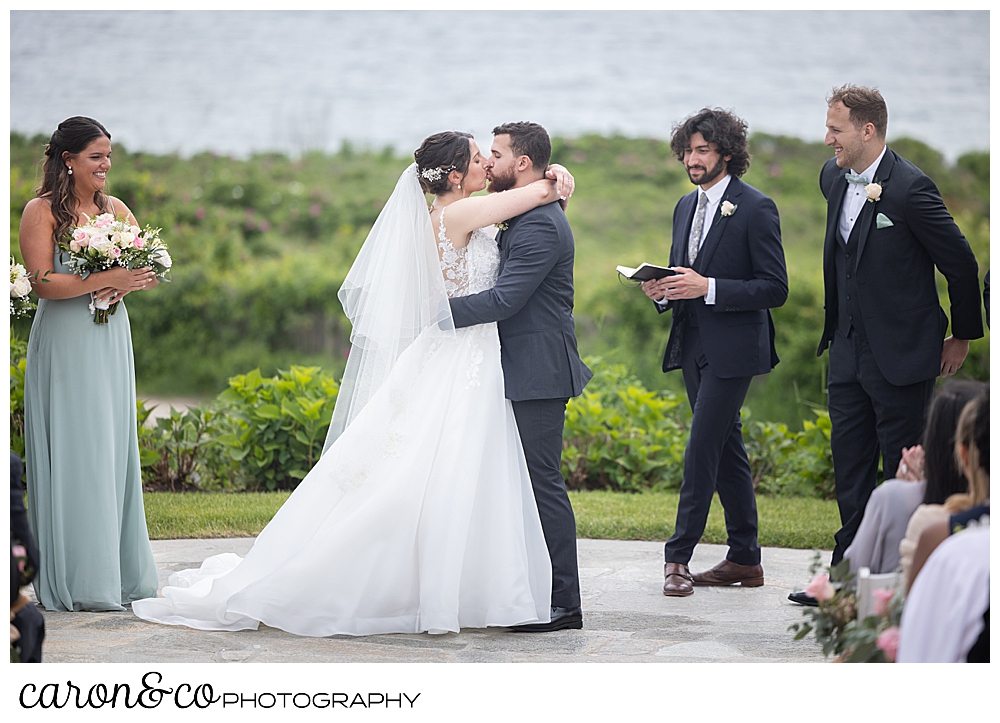 a bride and groom enjoy their first kiss at a colony hotel Kennebunkport Maine wedding ceremony