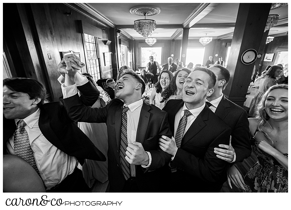 black and white photo of wedding guests on the dance floor