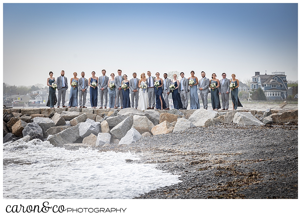 a twenty one person bridal party poses on the Breakwater at Colony Beach, Kennebunkport, Maine