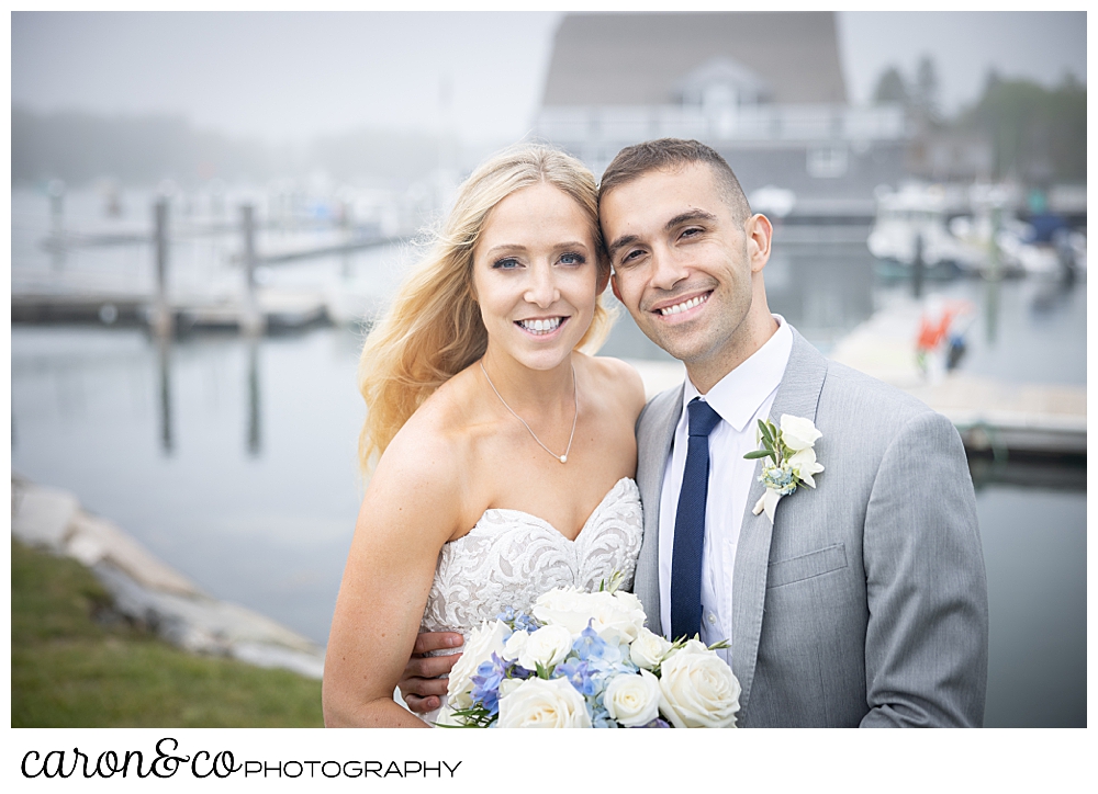 a bride and groom smiling together in a foggy Kennebunkport, Maine