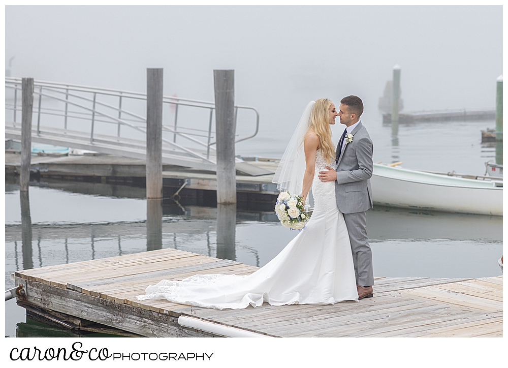 Bride and groom on the dock foggy Maine day